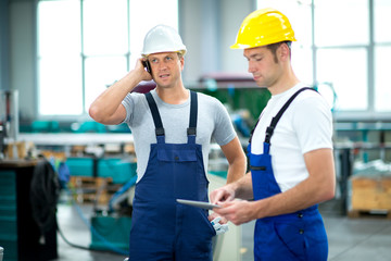two worker with phone and tablet PC