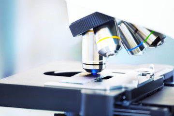 Microscope with blood sample background.