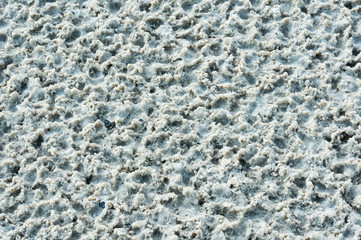 Sandy beach with holes caused by rainwater.