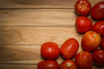 tomato on wooden background with space for text