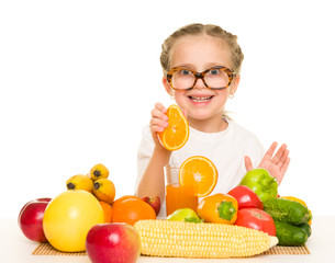 little girl with fruits and vegetables make juice