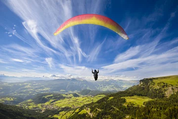 Tuinposter Paraglider flying over mountains © oneblink1