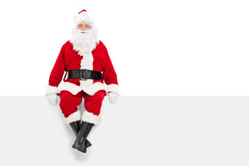 Santa Claus sitting on a blank billboard