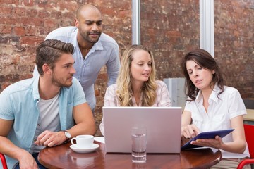 Business team talking and using tablet pc