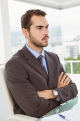 Fototapeta premium Thoughtful businessman looking away at office