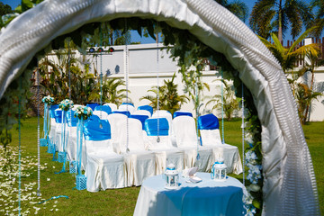 wedding ceremony flowers, arch, chairs