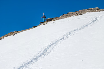 Naklejka na ściany i meble Skier of stones on a background of clear sky rise walk uphill 