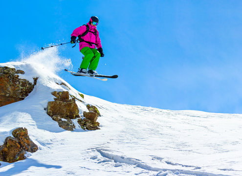 Skier jumping off a cliff