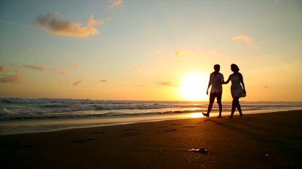 couple in love walking on the beach at sunset - Powered by Adobe
