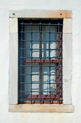 Fototapeta na wymiar Window with lattice in old building