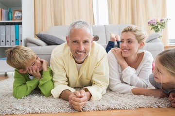 Happy parents with their children on floor