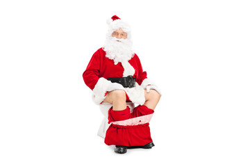 Santa Claus posing seated on a toilet