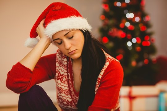 Festive brunette feeling sad at christmas