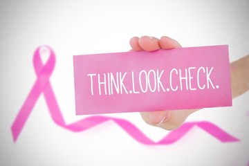 Composite image of young woman holding card