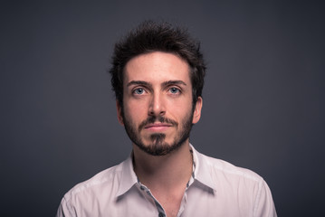 Man close up portrait against dark background.
