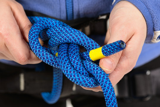 Female Hands Holding A Climbing Rope Making A Secure Node