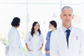 Fototapeta na wymiar Composite image of mature doctor standing