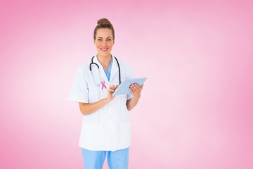 Composite image of pretty nurse using tablet pc