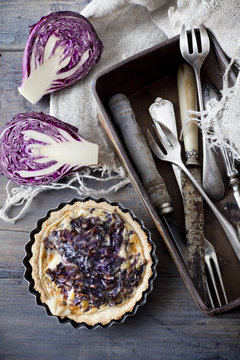 homemade purple cabbage quiche and vintage box with silverware