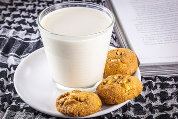 Milk, cookie and book
