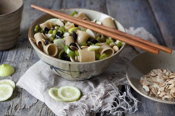pasta thai with lime, almond, olive and green pepperoni on bowl