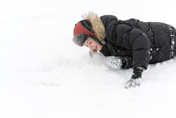 Fototapeta na wymiar Teenage boy playing snow in winter