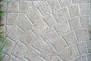 Gray stone tiles on the garden path as background