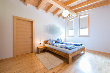 modern new bedroom in warm wooden timber house