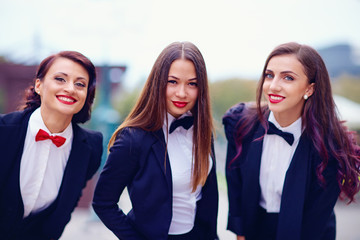 Fototapeta na wymiar elegant ladies in black suits outdoors