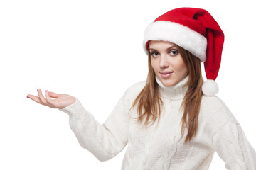 Woman in Santa Claus hat holds palm for blank ad space