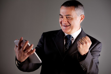 Senoir man using successfully a tablet