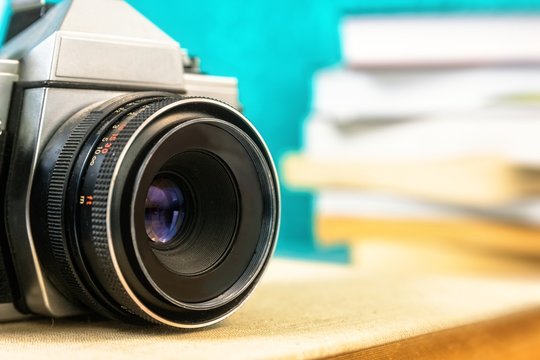 Old analog camera on books