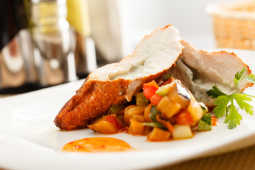 stuffed pork tenderloin roulade garnished with vegetables