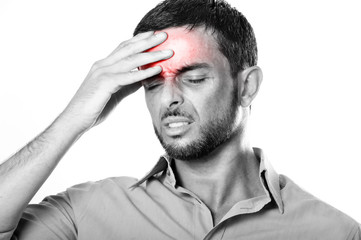 Young Man suffering Headache and migraine in pain expression