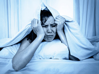 young woman in bed suffering stress insomnia sleeping disorder