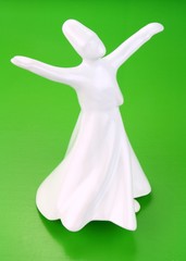 Whirling derwish on green background.