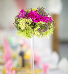 Flower bouquet in glass vase on dining table