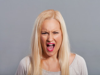 Frustrated young woman shouting.