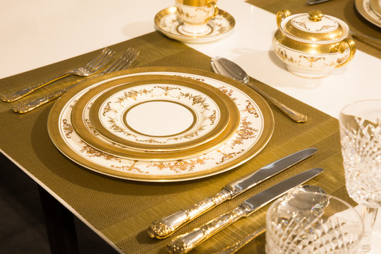 Elegant gold and white china plates in setting