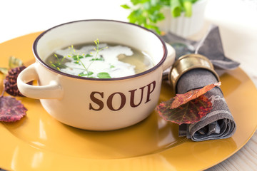 Soup of mushrooms on yellow plate. (Small depth of field)