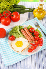 Scrambled egg with vegetables and sausage served in plate