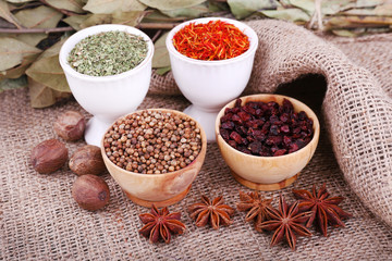 Small round tea and wooden bowls with different seasoning and