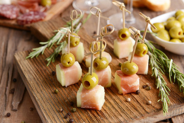 Delicious melon with prosciutto on table close-up