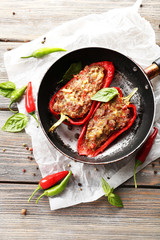 Delicious stuffed peppers in frying pan on table close-up