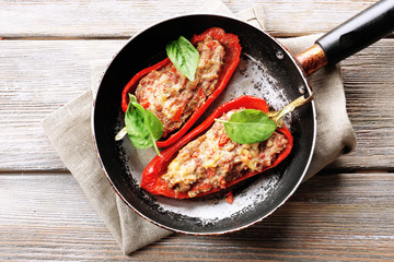 Delicious stuffed peppers in frying pan on table close-up