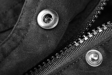 Zipper and button on clothes close up