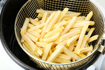 French fries in deep fryer, closeup