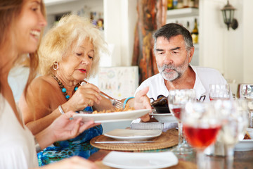 Multi Generation Family Enjoying Meal In Restaurant