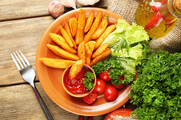 Homemade fried potato on plate on wooden background