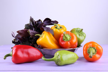 Pepper and basil on wooden background
